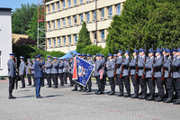 Komendant szkoły salutuje do sztandaru na placu apelowym